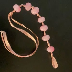 7 Round  1/2” Rose Quartz Beads Strung on a Pink Ribbon.